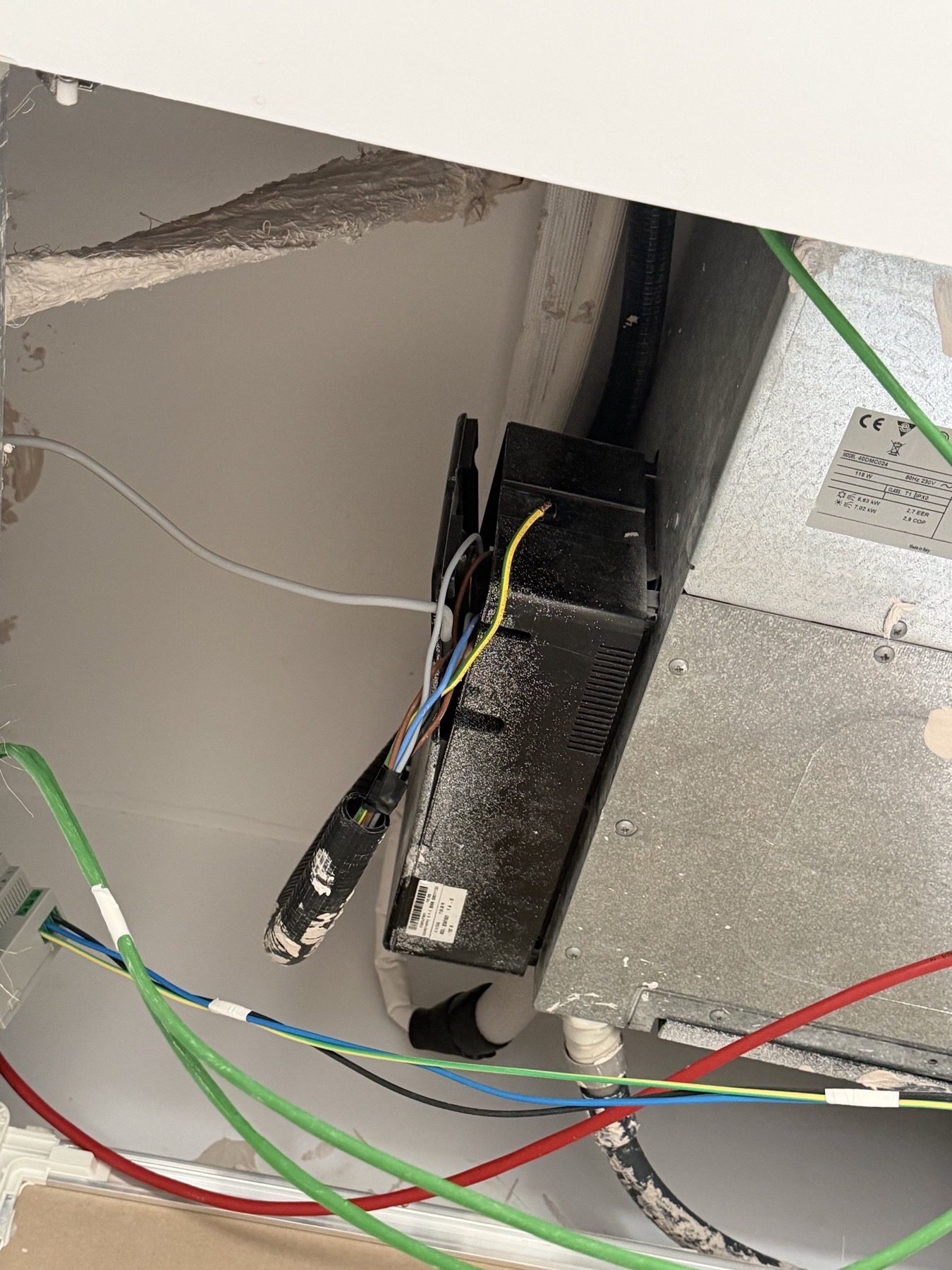Wiring left visible inside the open ceiling access.