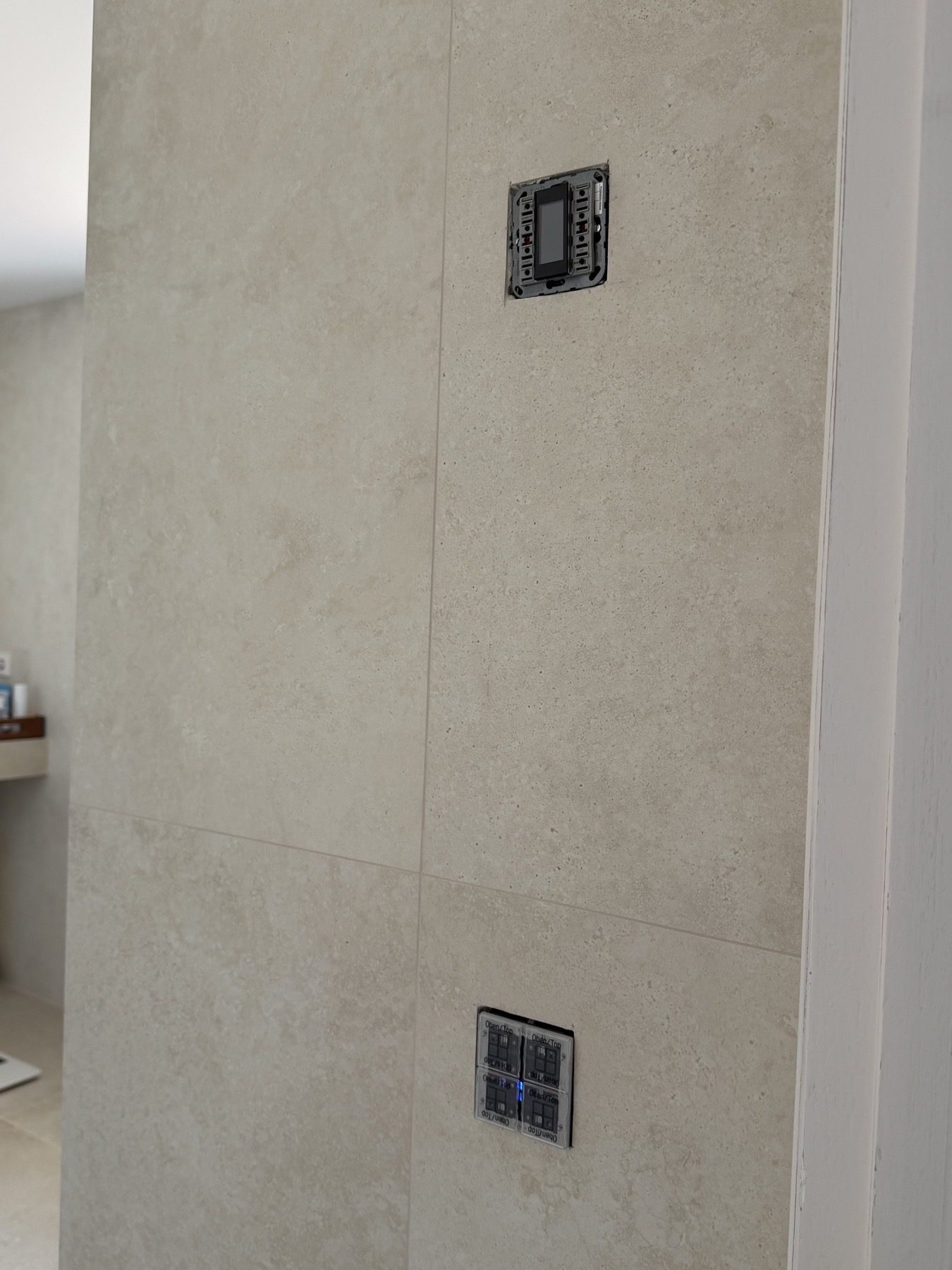 Wall controls left without their finished buttons and covers.
