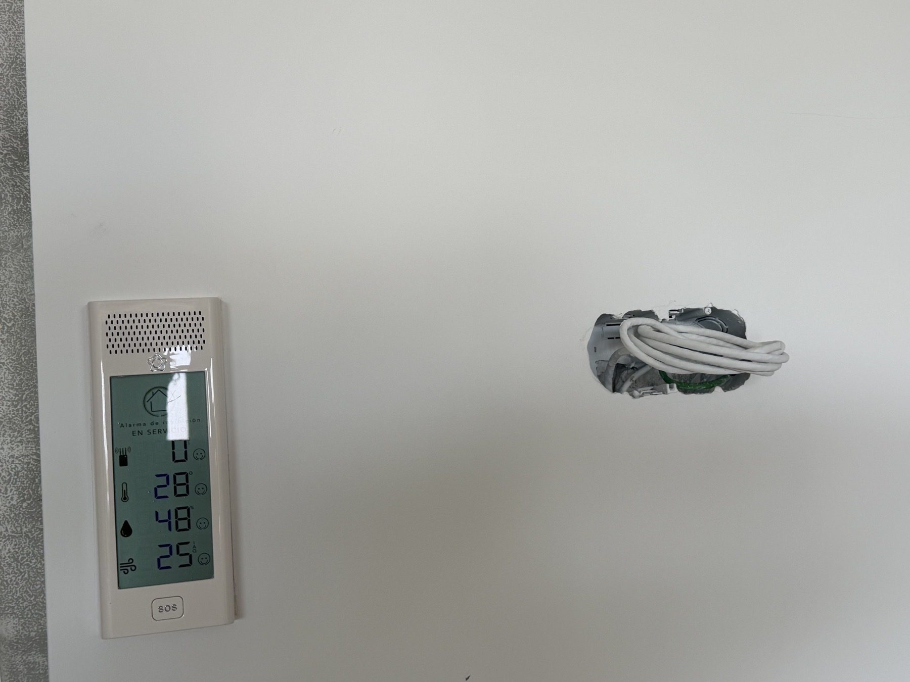 Open wall box with cable left coiled inside.