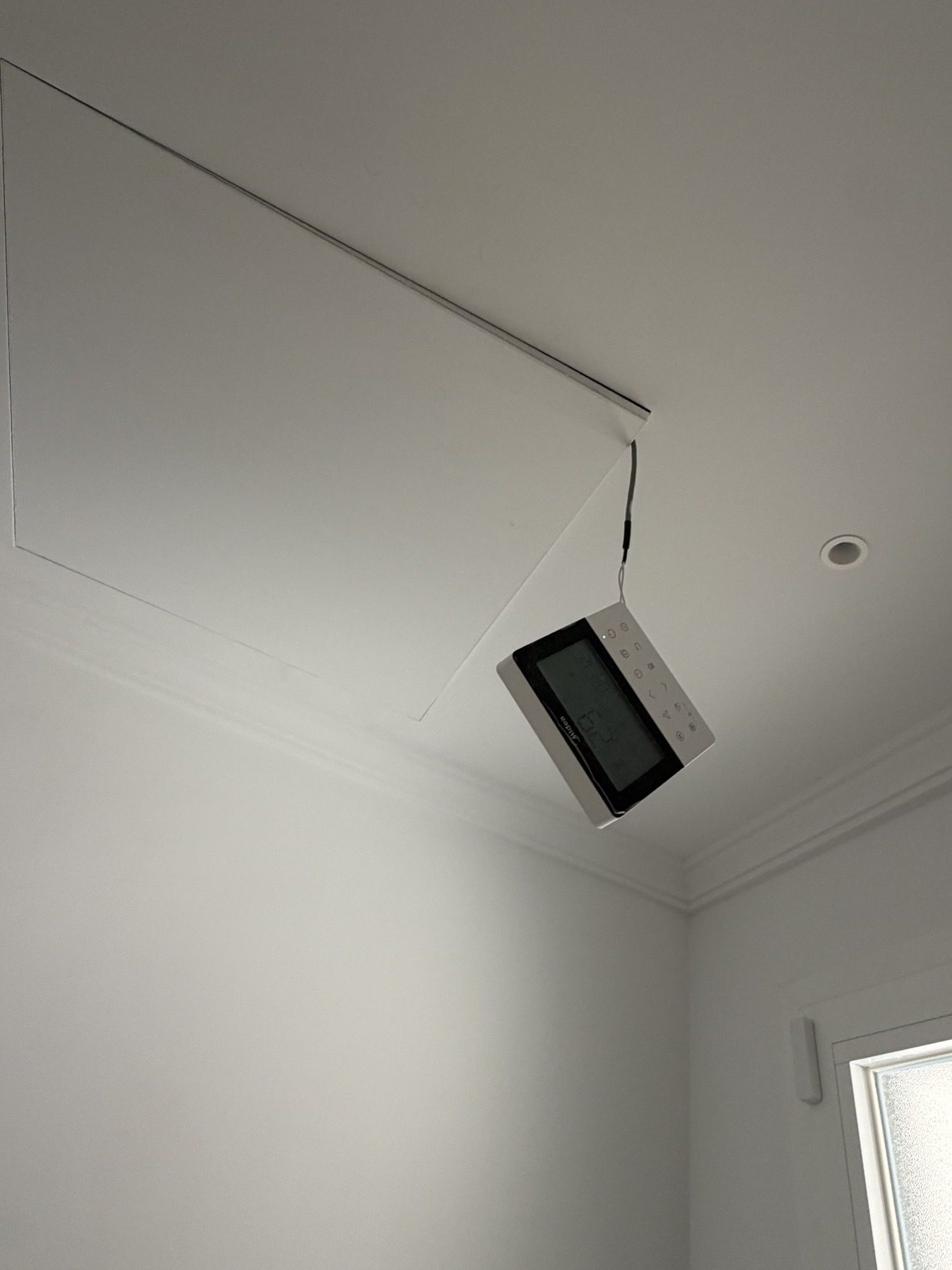 Control component left hanging below an open AC access.